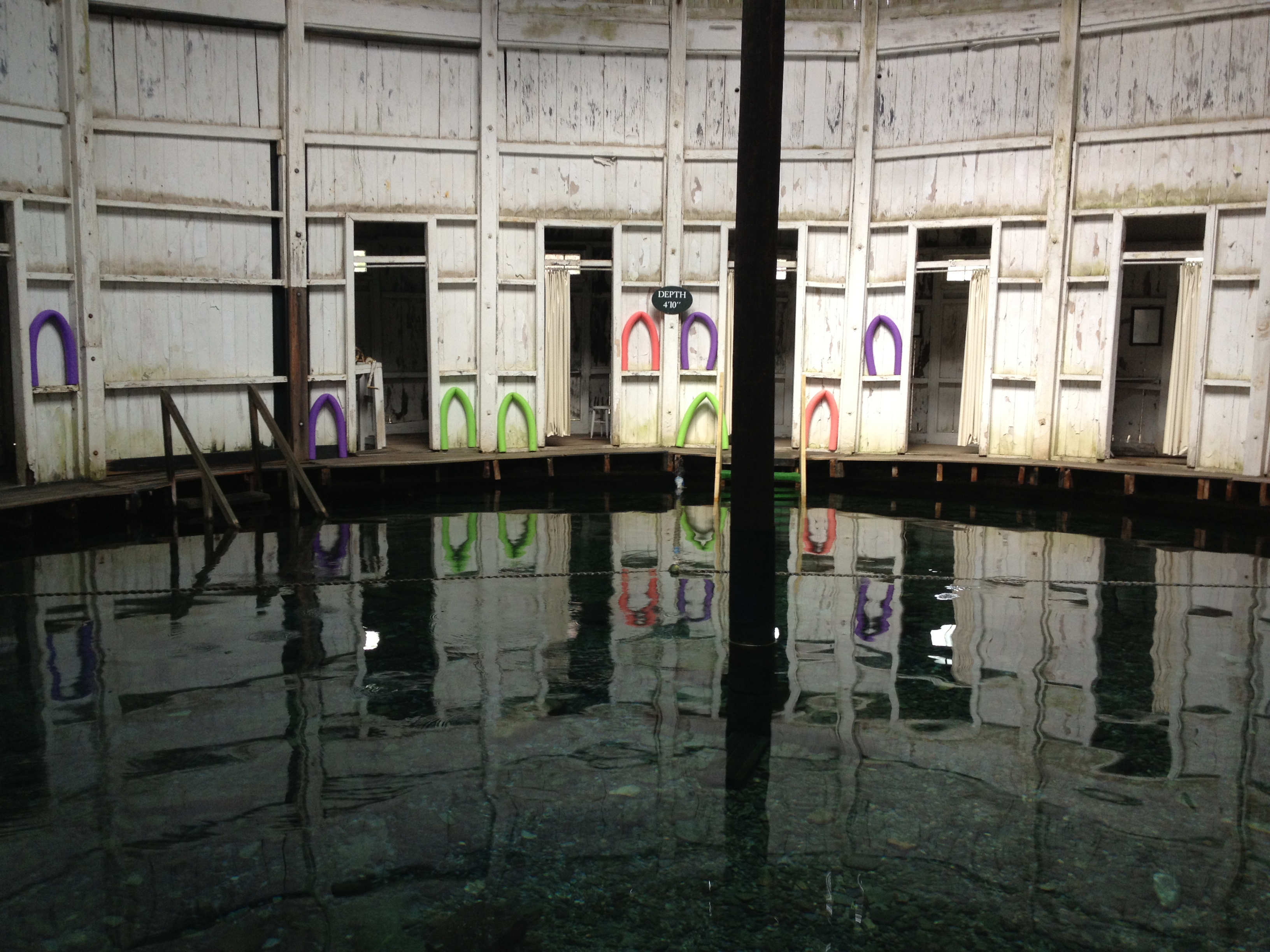Inside of circular hut showing noodles tucked in spaces of the wall.