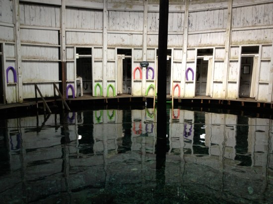 Inside of circular hut showing noodles tucked in spaces of the wall.