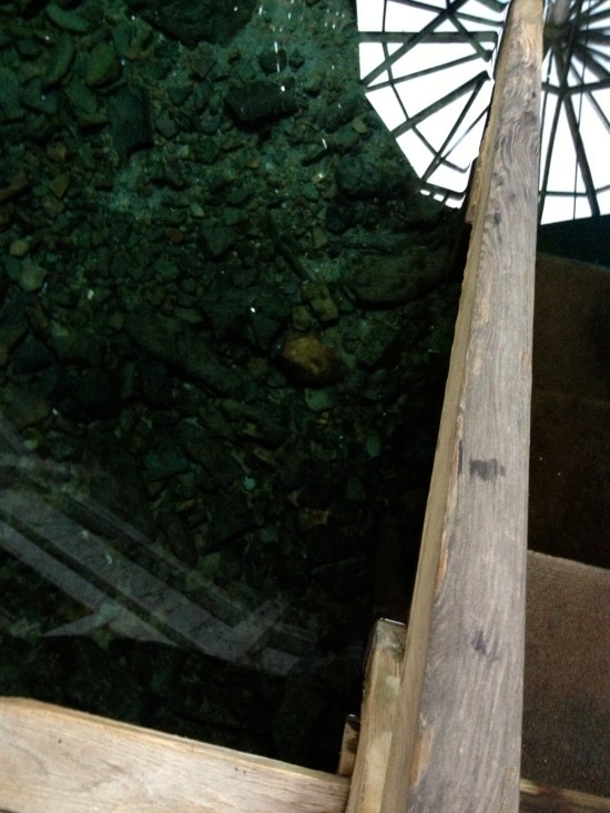 Reflection of central post attaching to center of roof in the healing waters.